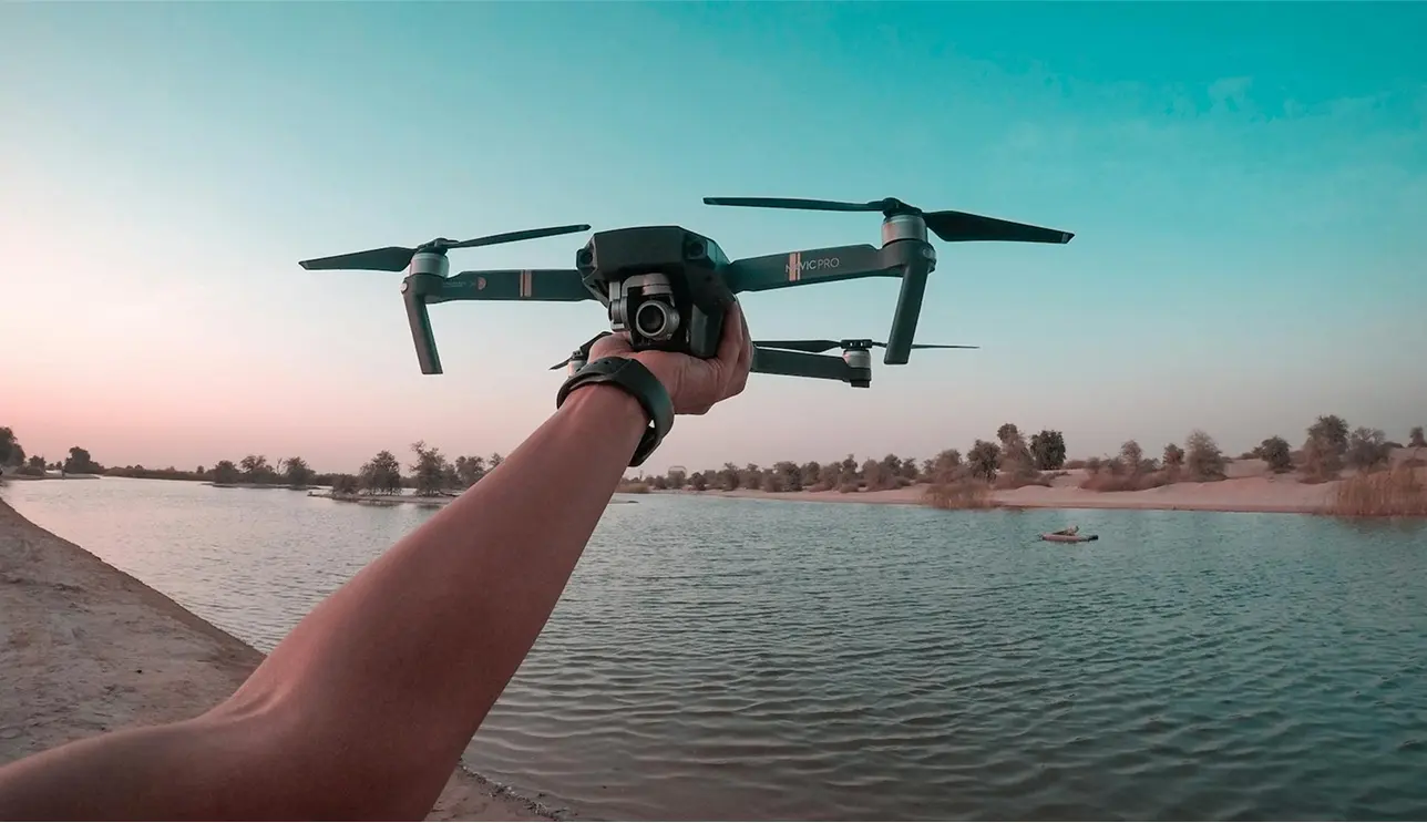 drone in extended hand at beach